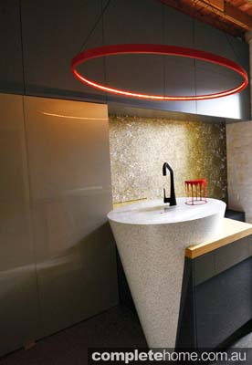 A dynamic conical sink and bar featured in a unique kitchen.