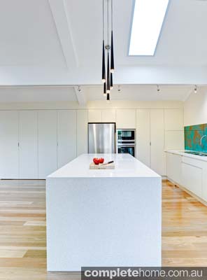 We love the acrylic couture malachite green splashbacks, which add intense colour and drama to the open kitchen.