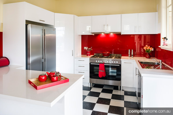 A retro kitchen with bright red splashback - Completehome