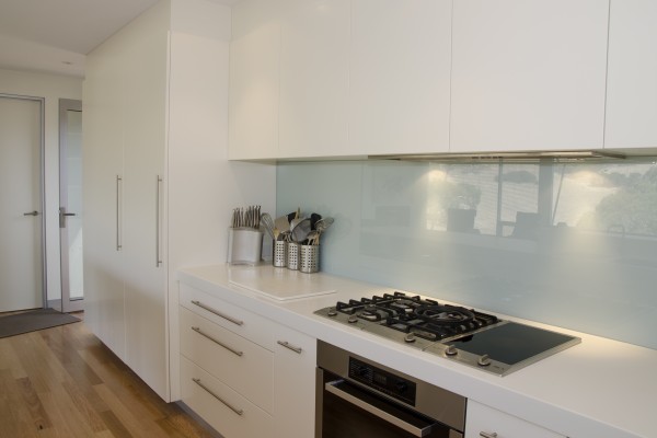 A Miele oven set in a kitchen with a minimalist deisng