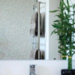 Gorgeous white bathroom with pearl tiles