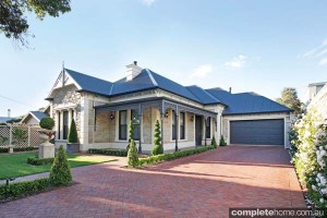 sandstone home with landscaped gardens