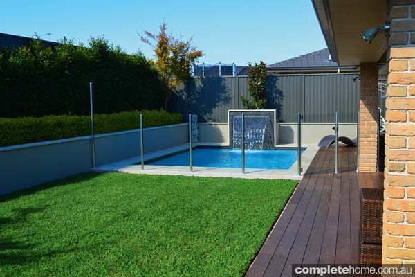 jakin pool with landscaping, fencing and water feature