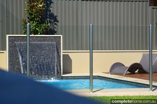 jakin pool with landscaping, fencing and water feature
