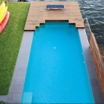 Simple pool next to a river view from above