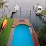A simple pool next to a wharf and a boat