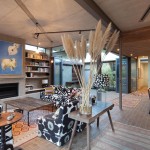 The placement of furniture helps split up the large main living area into different zones