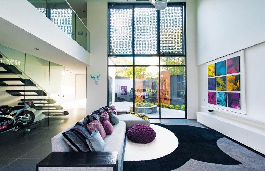 With its nod to mid-century architecture and a dash of industrial style, this modern family home by Canny Builders is a glass-fronted beauty.