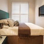 An architectural lamp adds a modern element to a relaxed guest bedroom