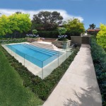 Corner view of a modern pool surrounded by a glass wall in the garden