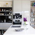 A white modern kitchen with a tap and flowers