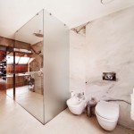 Marble walls create a luxe feel in a minimalist bathroom