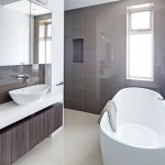 The dark, large-format tiles, with white gloss tiles for the side walls, creates a sense of grandeur