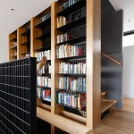 A bookcase between staircases mixes up the space