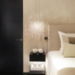 A chandelier besides the bed creates instant glamour