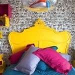 This room is all about the energy, clashing bright colours against the monochromatic wallpaper