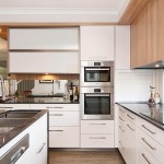 A simple modern kitchen with white pantry doors