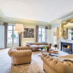 Chesterfield lounges evoke a sense of tradition in a room filled with gold