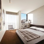 A spare bedroom is given character with an evocative art piece and the use of burned orange
