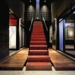 The red staircase serves as the meeting point of the two design styles