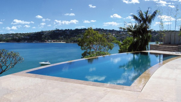 Infinity edge pool with waterfront views by A Total Concept