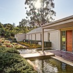 The moat adds an ethereal quality that complements the landscape