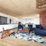 A brick wall provides contrast against the timber interior