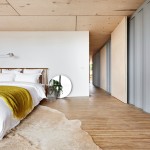 With so much warmth created by the floorboards, simple is best in the bedroom