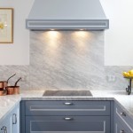 This compact kitchen design makes up for space by incorporating cupboards and drawers within a U-shaped bench