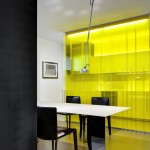 Yellow glass separates the kitchen and dining areas