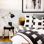 Squares quilt cover set and standard/European pillowcases in Graphite, Big Squares cushion and throw in Graphite, Maison Graphite standard pillowcase, Moss Stitch cushion in Dove Grey and Maison quilt cover in Pastel Pink. aurahome.com.au Alisa & Lysandra Even Score print, 90cm x 110cm. unitedartworks.net Guarida lamp in matt black and Kasket low table in black. cittadesign.com Dorsal Italy Ergo Posture slat bed base in beech and Bellagio timber headboard in beech. Stella Rubino Euro latex mattress. thecomfortshop.com.au Chantico rug. stonepony.com.au