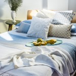 Jervis Blue cotton yarn dyed jacquard queen quilt set and long cushion, Cove Natural square cushion, Solaris White square cushion and Genevieve Linen decorator cushion. privatecollectionaustralia.com.au Night & Day by Wedgwood bed linen, Lattice Silver square cushion and Willow throw. wedgwoodbedlinen.com.au Cotton, hypo-allergenic quilt and feather pillows. loganandmason.com.au Oval platter in aqua. batchceramics.com Brisbane Zinc side table. orsonandblake.com.au Dorsal Italy Ergo Posture slat bed base in beech and Bellagio timber headboard in beech.  Stella Rubino Euro latex mattress. thecomfortshop.com.au