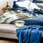 Pure linen quilt cover and pillowcase set in Deep Sea and pure  linen pillowcase set in Storm, Sunrise Dove and Grid organic  cotton throws. sheetsontheline.com.au Brisbane Zinc side table. orsonandblake.com.au Ethically sourced Australian red deer antler table lamp.  rapideffects.com.au Bench. camerich.com.au Dorsal Italy Ergo Posture slat bed base in beech and Bellagio timber headboard in beech. Stella Rubino Euro latex mattress. thecomfortshop.com.au Large resin Snow Swirl bowl from dinosaurdesigns.com.au
