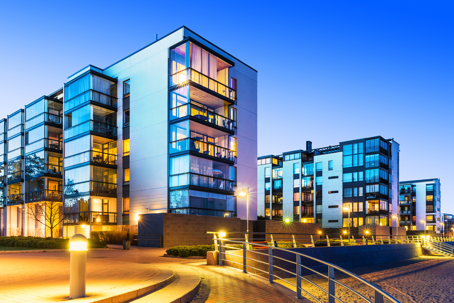House building and city construction concept: evening outdoor urban view of modern real estate homes